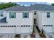 Attractive townhouse with white siding, teal shutters and a one car garage at 2956 Oak Park Way # B, Orlando, FL 32822