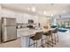 Modern kitchen featuring stainless steel appliances, a large island, and bar stool seating at 2956 Oak Park Way # B, Orlando, FL 32822
