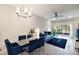 Open-concept living room with modern decor, a glass table and sliding glass door at 2956 Oak Park Way # B, Orlando, FL 32822