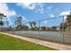 Fenced tennis courts with blue playing surface and well-maintained landscaping at 2956 Oak Park Way # B, Orlando, FL 32822