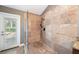 This shower features neutral tile, glass surround and matte black shower head at 308 Pine Shadow Ln, Lake Mary, FL 32746