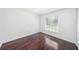 This bedroom features hardwood floors, a bright window and neutral walls at 308 Pine Shadow Ln, Lake Mary, FL 32746
