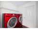 Laundry room features red washer and dryer and white walls at 308 Pine Shadow Ln, Lake Mary, FL 32746
