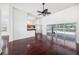 Open-concept living space with access to a pool area, featuring hardwood floors and white walls at 308 Pine Shadow Ln, Lake Mary, FL 32746