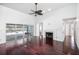 Bright living room featuring hardwood floors, fireplace, and sliding doors to the pool at 308 Pine Shadow Ln, Lake Mary, FL 32746