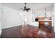 Bright living space showing seamless access to kitchen area with hardwood floors and bright walls at 308 Pine Shadow Ln, Lake Mary, FL 32746