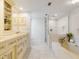 Bright bathroom with custom cabinets, dual sinks, soaking tub, and glass enclosed shower at 3420 Dawn Ct, Lake Mary, FL 32746