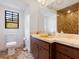 Bathroom featuring a window, toilet, and vanity with unique tiling at 3420 Dawn Ct, Lake Mary, FL 32746