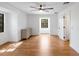 A simple bedroom with minimalist decor, light-colored wood floors, and two windows at 3420 Dawn Ct, Lake Mary, FL 32746