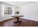 Bright dining room with wainscoting, hardwood floors, and a modern chandelier over a round dining table at 3420 Dawn Ct, Lake Mary, FL 32746