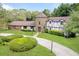 Charming home showcasing a stone turret, lush lawn, and a paved driveway at 3420 Dawn Ct, Lake Mary, FL 32746