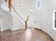 Grand foyer featuring high ceilings, hardwood floors, a curved staircase, and abundant natural light at 3420 Dawn Ct, Lake Mary, FL 32746