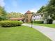 Beautiful front exterior with a stone turret, expansive lawn, and a welcoming driveway at 3420 Dawn Ct, Lake Mary, FL 32746
