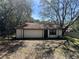 A detached garage offers parking space with a conventional garage door in a tree-covered lot at 3420 Dawn Ct, Lake Mary, FL 32746