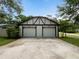 Spacious two-car garage with Tudor-style accents and a concrete driveway at 3420 Dawn Ct, Lake Mary, FL 32746