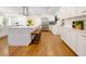 Spacious white kitchen offers stainless appliances, hardwood floors, and island seating for casual dining at 3420 Dawn Ct, Lake Mary, FL 32746