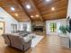 Cozy living room featuring a stone fireplace, wood-beamed ceiling, hardwood floors, and comfortable seating at 3420 Dawn Ct, Lake Mary, FL 32746