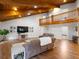 Open living room with a wood-beamed ceiling, hardwood floors, and a second floor balcony at 3420 Dawn Ct, Lake Mary, FL 32746