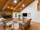 Relaxing living room with a stone fireplace, wood-beamed ceiling, and comfortable seating area at 3420 Dawn Ct, Lake Mary, FL 32746