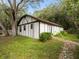 Side angle of a small outbuilding with white and brown wood and a stone walkway at 3420 Dawn Ct, Lake Mary, FL 32746