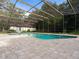 Backyard pool features screen enclosure and stone tiled patio at 3420 Dawn Ct, Lake Mary, FL 32746