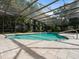 Enclosed pool surrounded by stone tile and lush tropical greenery at 3420 Dawn Ct, Lake Mary, FL 32746
