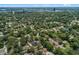 An aerial view showcasing the homes in a suburban neighborhood with manicured lawns, mature trees, and city views at 356 Oakhurst St, Altamonte Springs, FL 32701