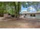 Spacious backyard featuring mature trees, a shed, partial fencing and a home with light grey exterior at 356 Oakhurst St, Altamonte Springs, FL 32701