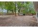 Spacious backyard with mature trees, partial fencing and a shed at 356 Oakhurst St, Altamonte Springs, FL 32701