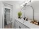 Well-lit bathroom featuring a modern vanity, a sleek mirror, and a walk-in shower at 356 Oakhurst St, Altamonte Springs, FL 32701