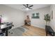 Bedroom featuring a desk area, wood floors, a large window providing light, and neutral paint at 356 Oakhurst St, Altamonte Springs, FL 32701