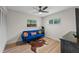 Bright bedroom with a blue couch, stylish decor, hardwood floors, and natural light from the windows at 356 Oakhurst St, Altamonte Springs, FL 32701