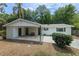 Charming single-story home featuring a covered front porch, fresh paint, and a well-maintained landscape at 356 Oakhurst St, Altamonte Springs, FL 32701