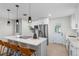 Modern kitchen with white cabinets, stainless steel appliances, island seating, and stylish pendant lighting at 356 Oakhurst St, Altamonte Springs, FL 32701
