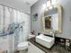 Modern bathroom with stylish vanity, elegant mirror, and unique turtle shower curtain at 38241 County Road 439, Eustis, FL 32736