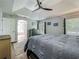 Comfortable bedroom with tray ceiling, dresser, and view of the ensuite bathroom at 38241 County Road 439, Eustis, FL 32736