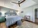 Serene bedroom with a tray ceiling, unique decor, and wood-look flooring at 38241 County Road 439, Eustis, FL 32736
