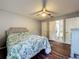 Cozy bedroom featuring a ceiling fan, wood-look floors, and a lovely ensuite bathroom at 38241 County Road 439, Eustis, FL 32736