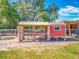 Charming chicken coop with red accents, providing a safe and functional space at 38241 County Road 439, Eustis, FL 32736