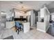 Modern kitchen with white cabinetry, stainless steel appliances, granite countertops, and a stylish kitchen island with seating at 38241 County Road 439, Eustis, FL 32736