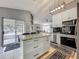 Contemporary kitchen with a center island, stainless steel appliances, and a sliding door to a screened in patio at 38241 County Road 439, Eustis, FL 32736