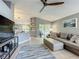 Bright and airy living room featuring a large sectional sofa and open access to the kitchen at 38241 County Road 439, Eustis, FL 32736