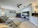 Inviting living room featuring a cozy fireplace, neutral color scheme, and tile flooring at 38241 County Road 439, Eustis, FL 32736