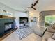 Open-concept living area with a fireplace and seamless transition to the kitchen and sliding glass door at 38241 County Road 439, Eustis, FL 32736