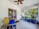 Enclosed patio area featuring a ceiling fan, outdoor furniture, and relaxing views at 38241 County Road 439, Eustis, FL 32736
