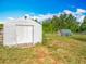 A white storage shed with a backyard greenhouse is available for gardening and storage at 38241 County Road 439, Eustis, FL 32736
