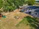 Aerial view of a large backyard with a playset, trampoline and outdoor seating area at 39 Lake Dr, Debary, FL 32713