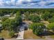 Aerial view displays home with an expansive yard, mature trees, and long driveway at 39 Lake Dr, Debary, FL 32713