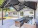 Covered patio showcasing outdoor seating with a lounge area, backyard trampoline, and house access at 39 Lake Dr, Debary, FL 32713