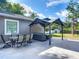 Outdoor patio features a seating area with a pergola and a dining table in the backyard at 39 Lake Dr, Debary, FL 32713